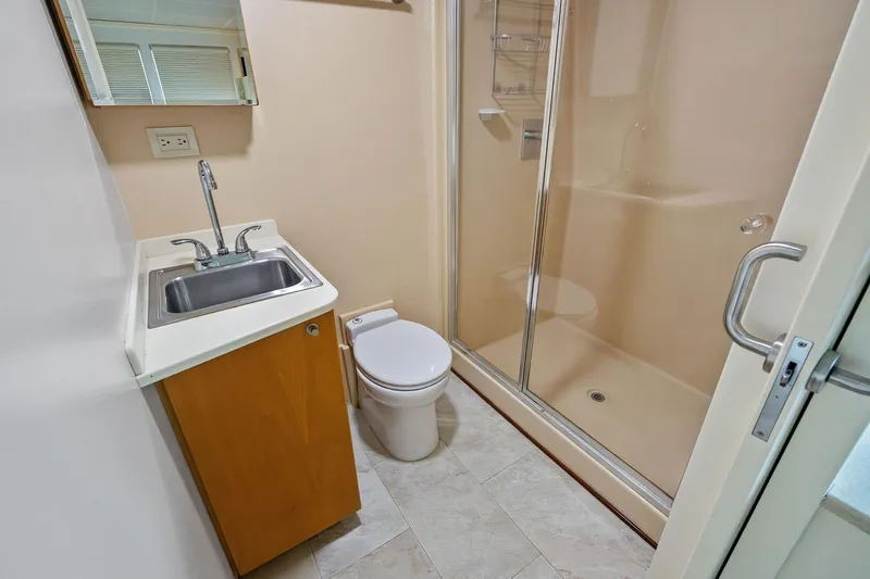 Pegasus Ix Yacht Photos Pics Compact bathroom in 2004 Sabre 92 with shower, sink, and toilet.