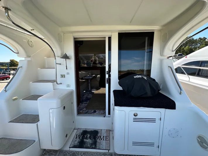 Cocktails & Dreams Yacht Photos Pics 2004 Silverton 38 Convertible yacht interior with stairs, welcome mat, and sliding glass door.