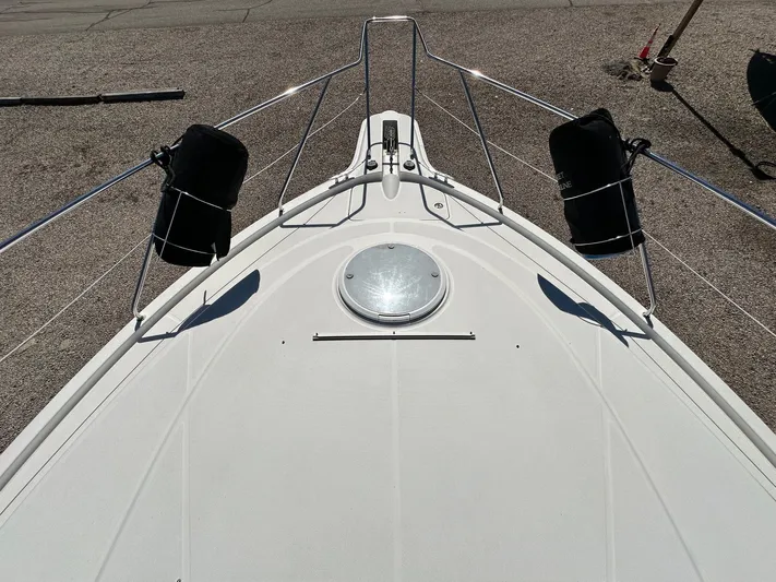 Cocktails & Dreams Yacht Photos Pics 2004 Silverton 38 Convertible boat deck with railings and hatch.