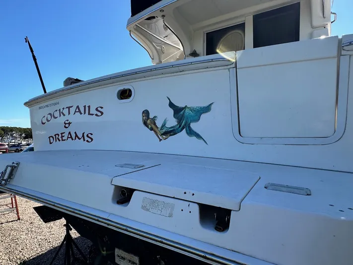 Cocktails & Dreams Yacht Photos Pics 2004 Silverton 38 Convertible boat with "Cocktails & Dreams" and mermaid art on the stern.