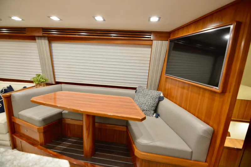 Slow Your Roll Yacht Photos Pics Luxurious interior of 2019 Viking 68 Convertible yacht with wood finish and seating area.