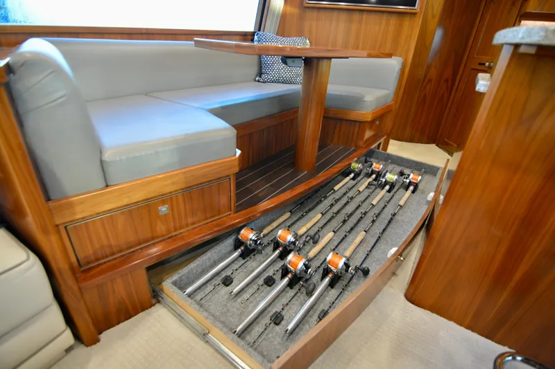 Slow Your Roll Yacht Photos Pics 2019 Viking 68 Convertible yacht interior with fishing rod storage under seating.