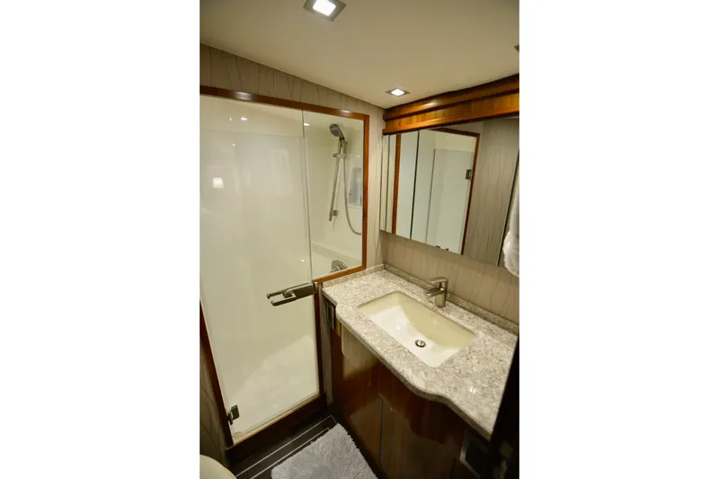 Slow Your Roll Yacht Photos Pics Luxurious bathroom in 2019 Viking 68 Convertible yacht with modern fixtures and elegant design.