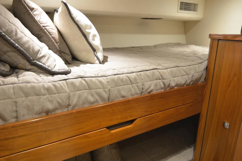 Slow Your Roll Yacht Photos Pics Cozy cabin bed in 2019 Viking 68 Convertible yacht with wooden accents and plush pillows.
