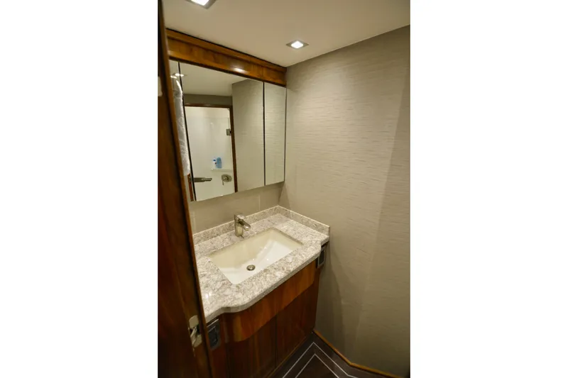 Slow Your Roll Yacht Photos Pics Luxurious bathroom in 2019 Viking 68 Convertible yacht with modern sink and mirror.