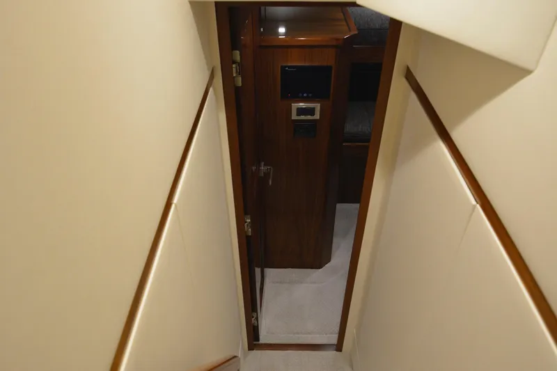 Slow Your Roll Yacht Photos Pics Stairway leading to cabin interior of 2019 Viking 68 Convertible yacht.
