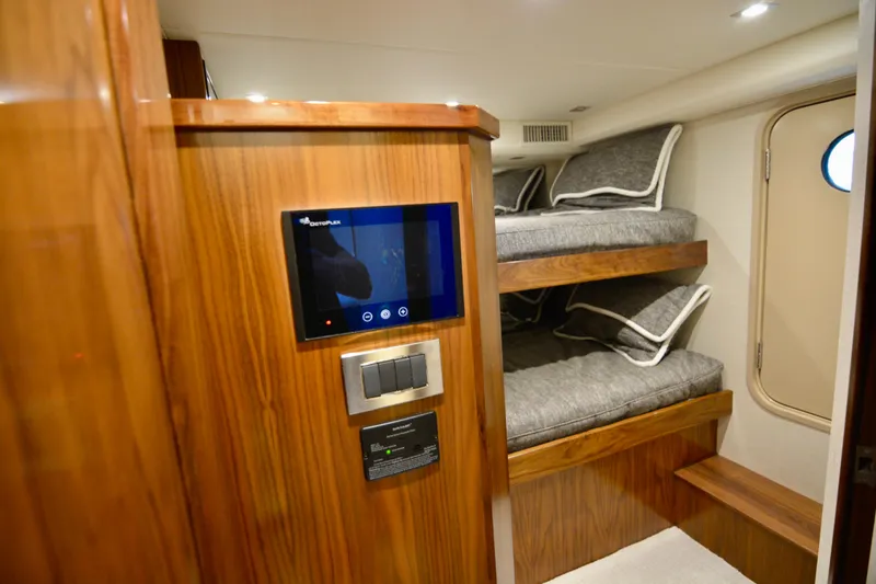 Slow Your Roll Yacht Photos Pics 2019 Viking 68 Convertible yacht interior with bunk beds and control panel.