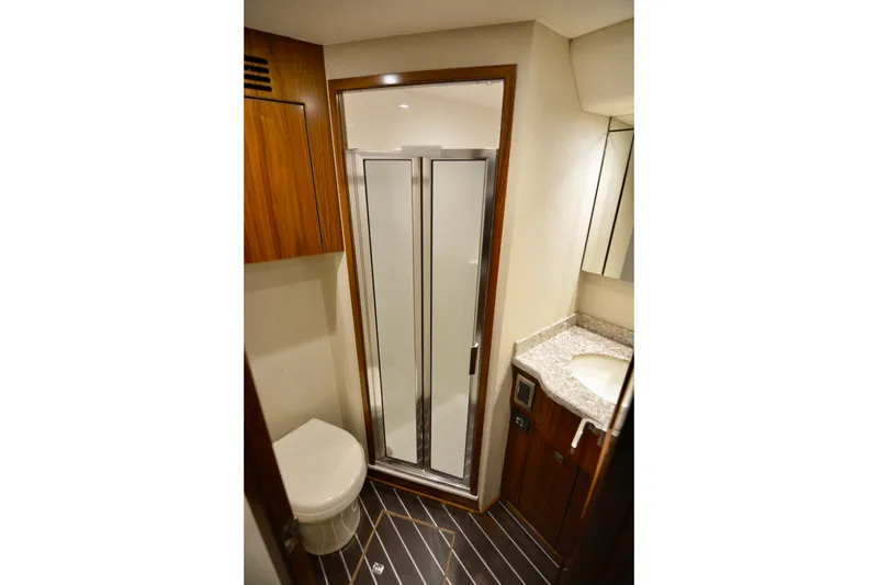 Slow Your Roll Yacht Photos Pics Luxurious bathroom in 2019 Viking 68 Convertible yacht with shower and wooden accents.