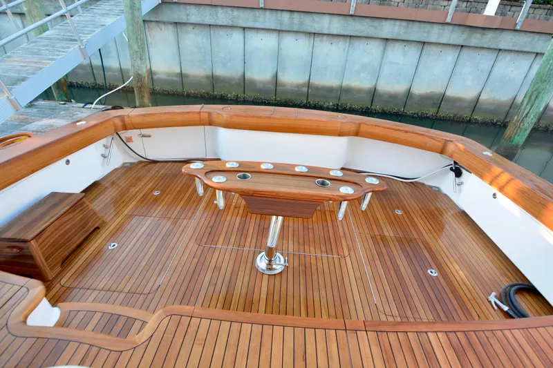 Slow Your Roll Yacht Photos Pics Luxurious teak deck of 2019 Viking 68 Convertible yacht with fishing rod holders.