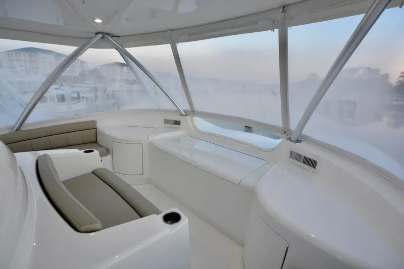 Slow Your Roll Yacht Photos Pics Luxurious interior of 2019 Viking 68 Convertible yacht with panoramic windows and seating.
