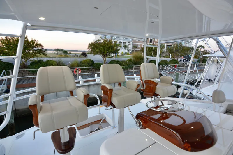 Slow Your Roll Yacht Photos Pics 2019 Viking 68 Convertible yacht helm with luxurious seating and polished wood accents.