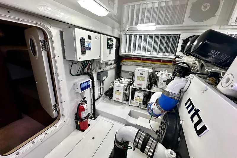 Slow Your Roll Yacht Photos Pics Engine room of 2019 Viking 68 Convertible yacht with MTU components and control panels.