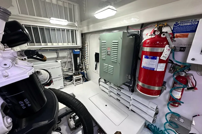 Slow Your Roll Yacht Photos Pics Engine room of 2019 Viking 68 Convertible yacht with fire extinguisher and equipment.