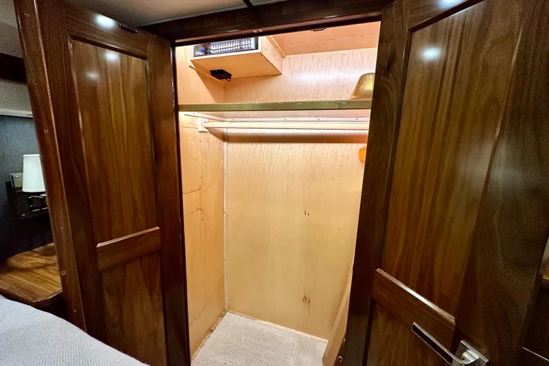Slow Your Roll Yacht Photos Pics Wooden closet interior on a 2019 Viking 68 Convertible yacht.