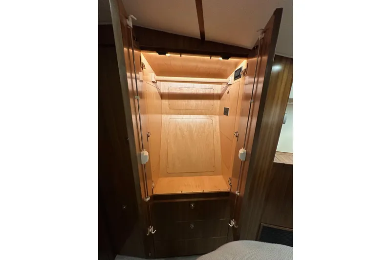 Slow Your Roll Yacht Photos Pics 2019 Viking 68 Convertible yacht interior closet with wooden finish and lighting.