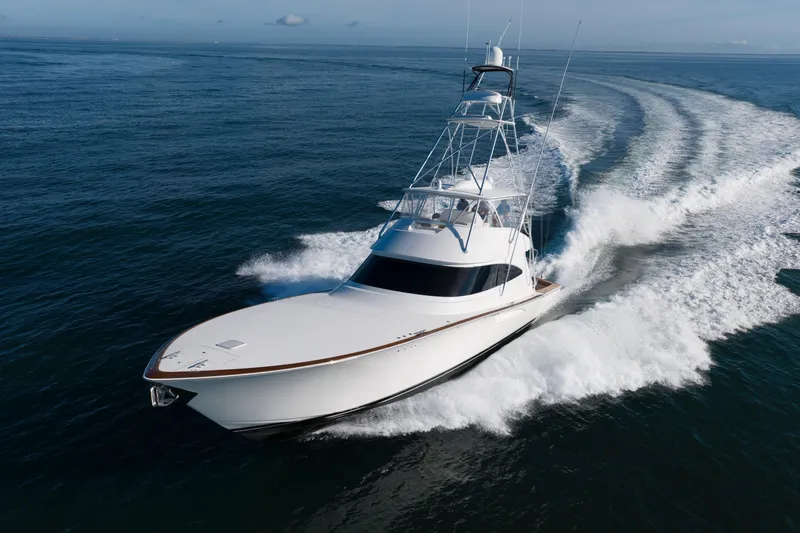 Slow Your Roll Yacht Photos Pics 2019 Viking 68 Convertible yacht cruising on open water, creating a dynamic wake.