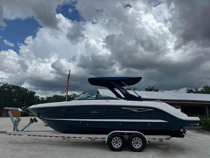  Yacht Photos Pics 2021 Sea Ray SLX 280 boat on trailer under cloudy sky.