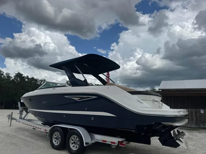  Yacht Photos Pics 2021 Sea Ray SLX 280 boat on trailer under cloudy sky.