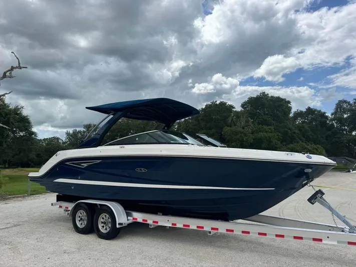  Yacht Photos Pics 2021 Sea Ray SLX 280 boat on trailer under cloudy sky.