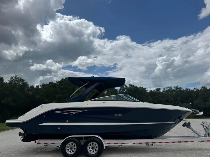  Yacht Photos Pics 2021 Sea Ray SLX 280 boat on trailer under cloudy sky.