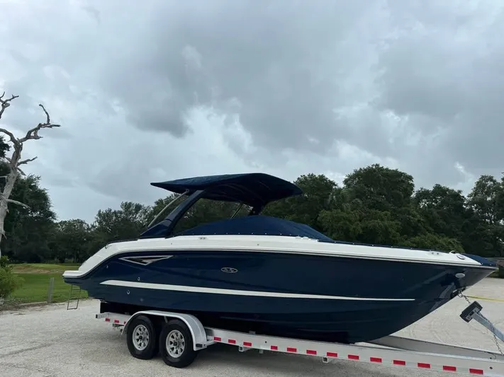  Yacht Photos Pics 2021 Sea Ray SLX 280 boat on trailer under cloudy sky.