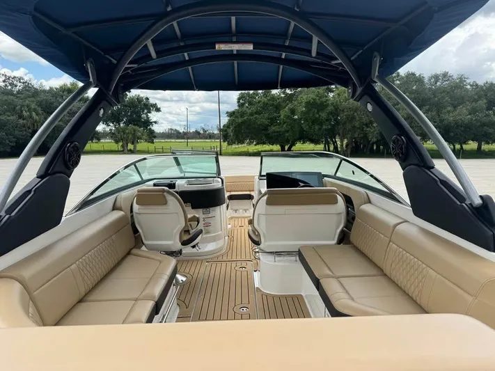  Yacht Photos Pics 2021 Sea Ray SLX 280 boat interior with tan seating and canopy.