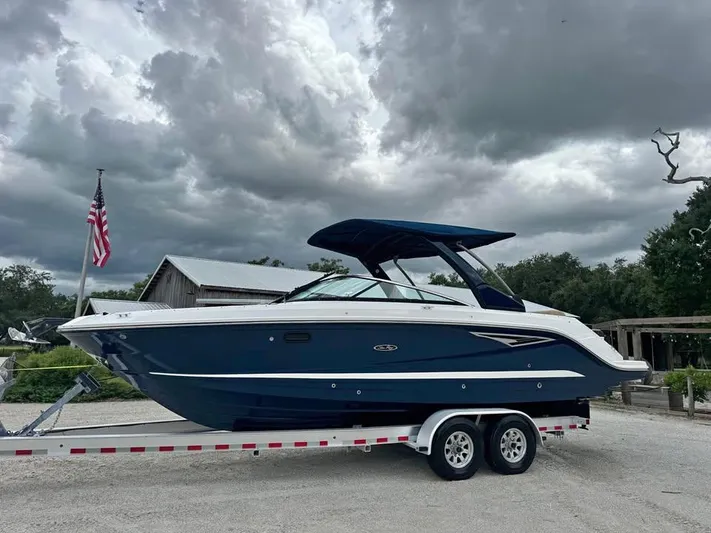  Yacht Photos Pics 2021 Sea Ray SLX 280 boat on trailer under cloudy sky.