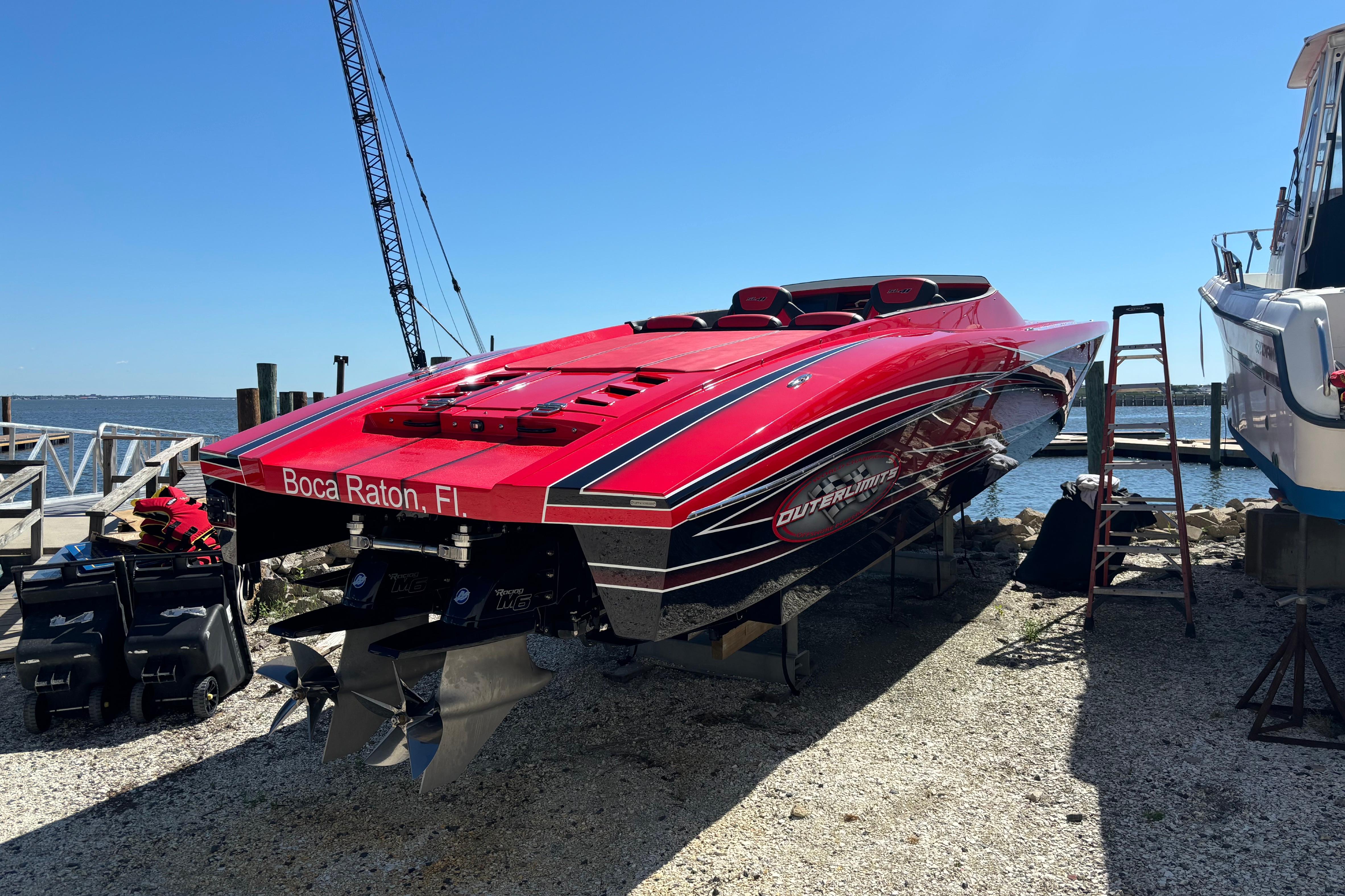 2022 Outerlimits SL41 speedboat in Boca Raton, FL, docked by the waterfront.