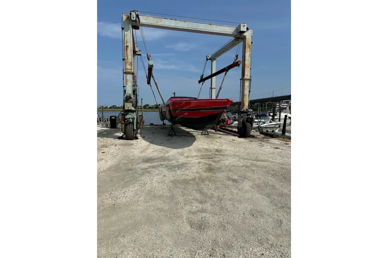  Yacht Photos Pics 2022 Outerlimits SL41 boat on a lift at a marina.