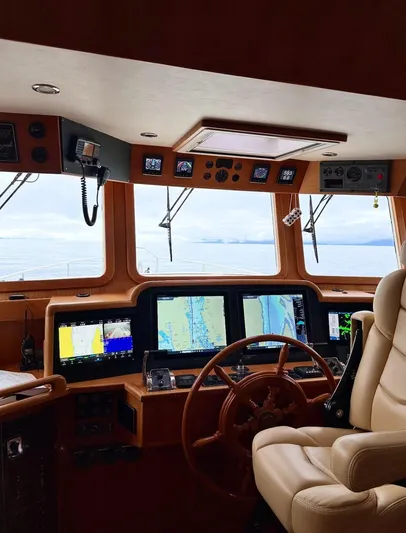 Blue Red Yacht Photos Pics Pilothouse interior of 2006 Selene Ocean Trawler with navigation screens and steering wheel.