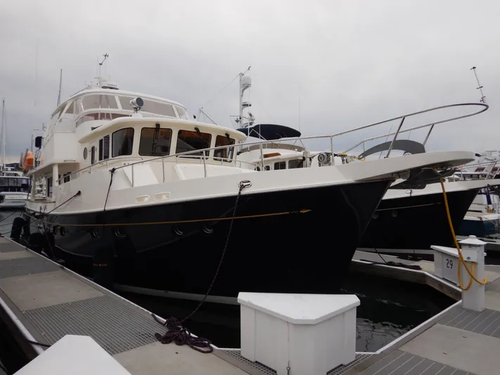 Blue Red Yacht Photos Pics 2006 Selene Pilothouse Ocean Trawler docked at marina, showcasing sleek design and spacious deck.
