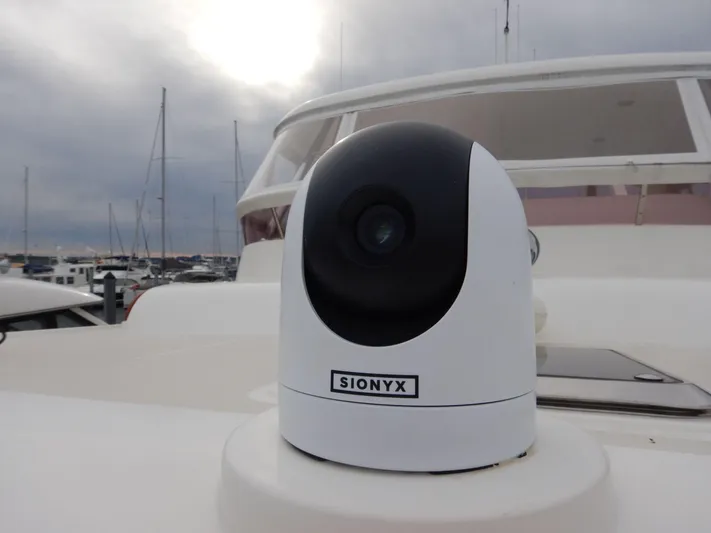 Blue Red Yacht Photos Pics SIONYX camera on 2006 Selene Pilothouse Ocean Trawler, docked with cloudy sky background.
