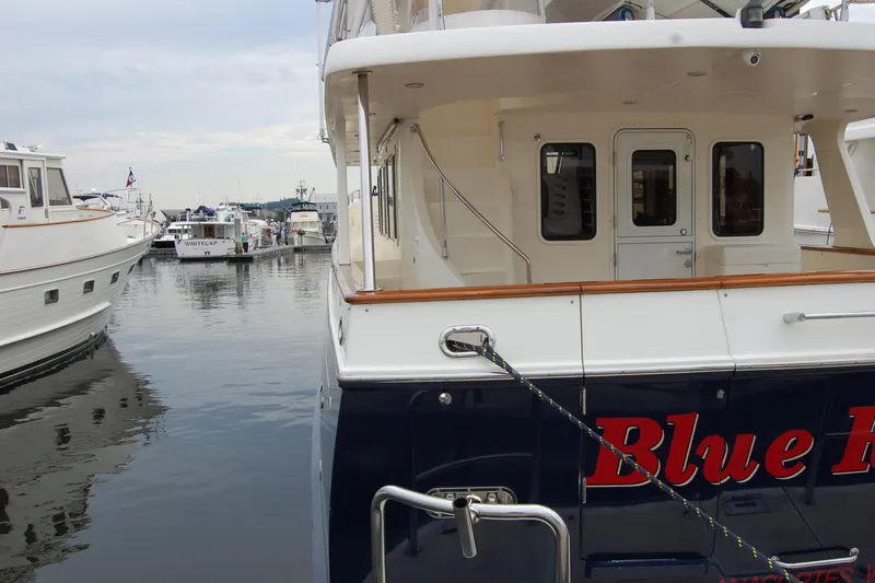 Blue Red Yacht Photos Pics 2006 Selene Pilothouse Ocean Trawler docked at marina, rear view.