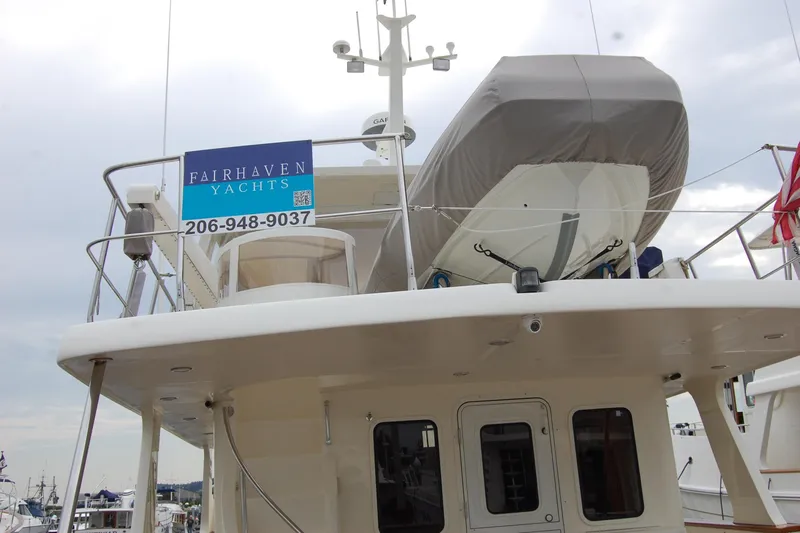 Blue Red Yacht Photos Pics 2006 Selene Pilothouse Ocean Trawler with dinghy and Fairhaven Yachts sign.
