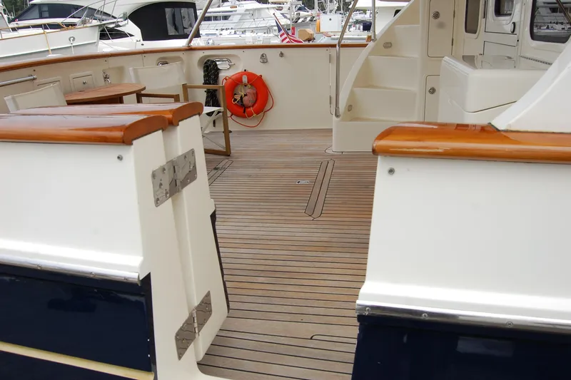 Blue Red Yacht Photos Pics 2006 Selene Pilothouse Ocean Trawler deck with wooden flooring and seating area.