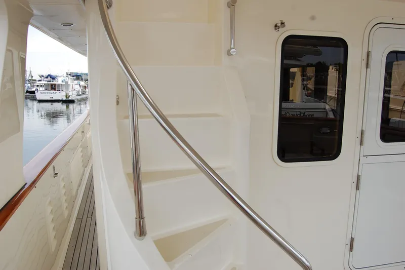 Blue Red Yacht Photos Pics 2006 Selene Pilothouse Ocean Trawler staircase and door, docked at marina.