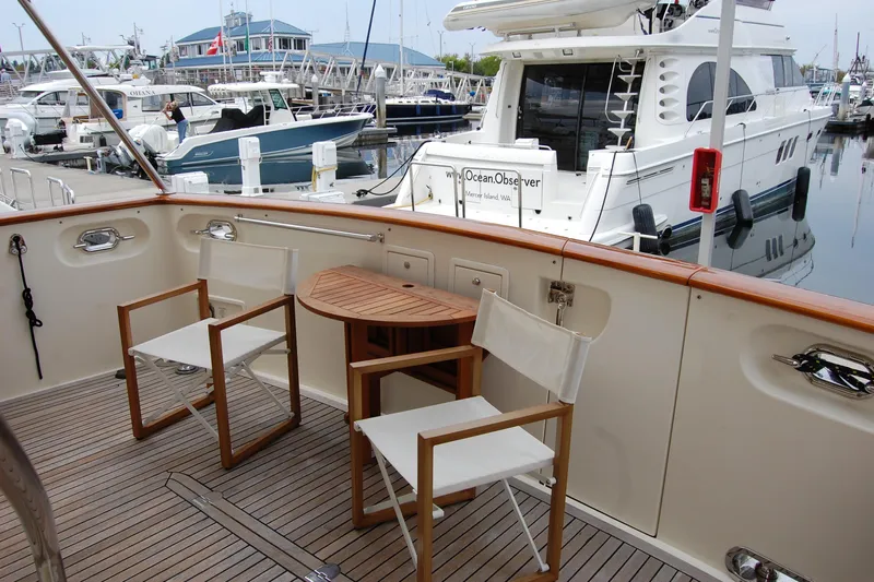 Blue Red Yacht Photos Pics Deck of 2006 Selene Pilothouse Ocean Trawler with chairs and table, marina view.