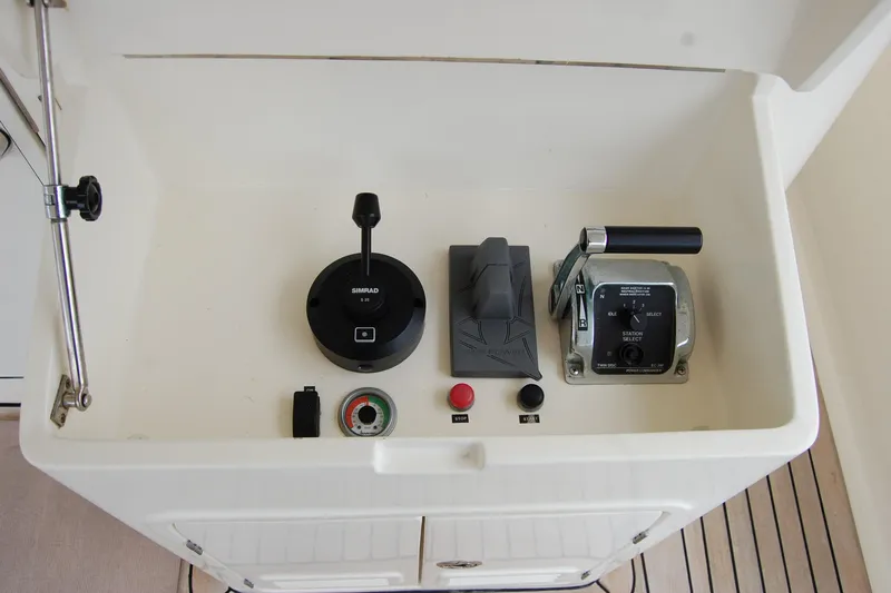 Blue Red Yacht Photos Pics Control panel of 2006 Selene Pilothouse Ocean Trawler with navigation and throttle controls.