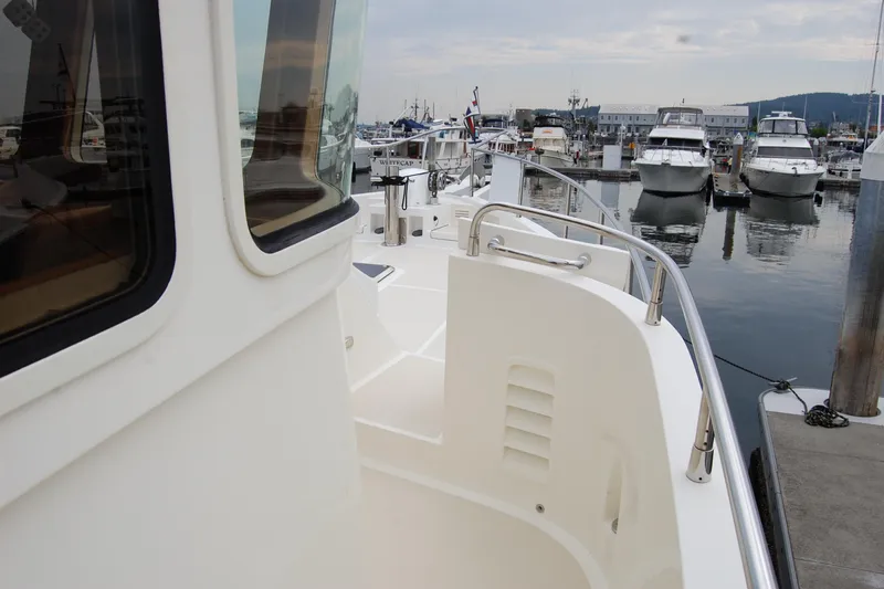 Blue Red Yacht Photos Pics 2006 Selene Pilothouse Ocean Trawler docked at marina, showcasing sleek design and spacious deck.