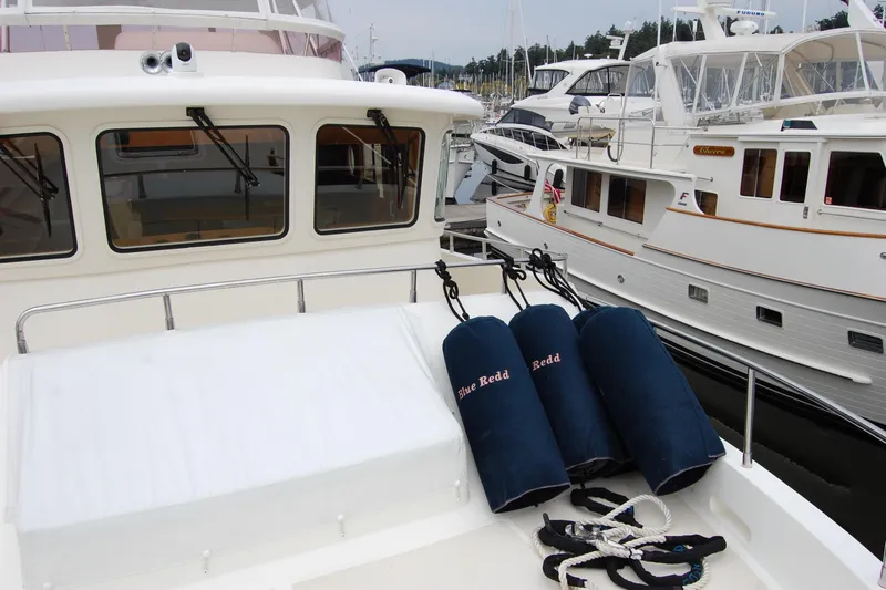 Blue Red Yacht Photos Pics 2006 Selene Pilothouse Ocean Trawler docked with fenders and ropes visible.