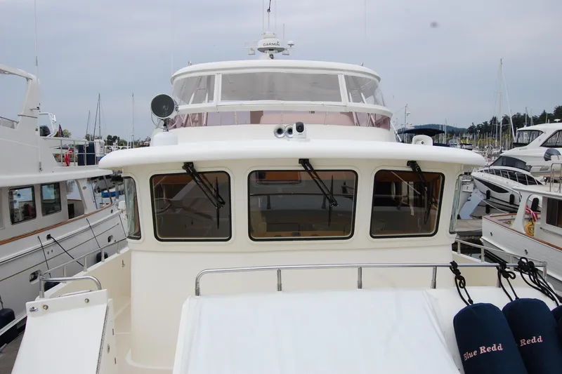 Blue Red Yacht Photos Pics 2006 Selene Pilothouse Ocean Trawler docked at marina, front view.