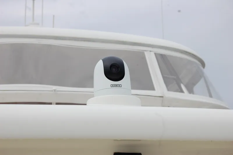 Blue Red Yacht Photos Pics Security camera on 2006 Selene Pilothouse Ocean Trawler, with overcast sky background.