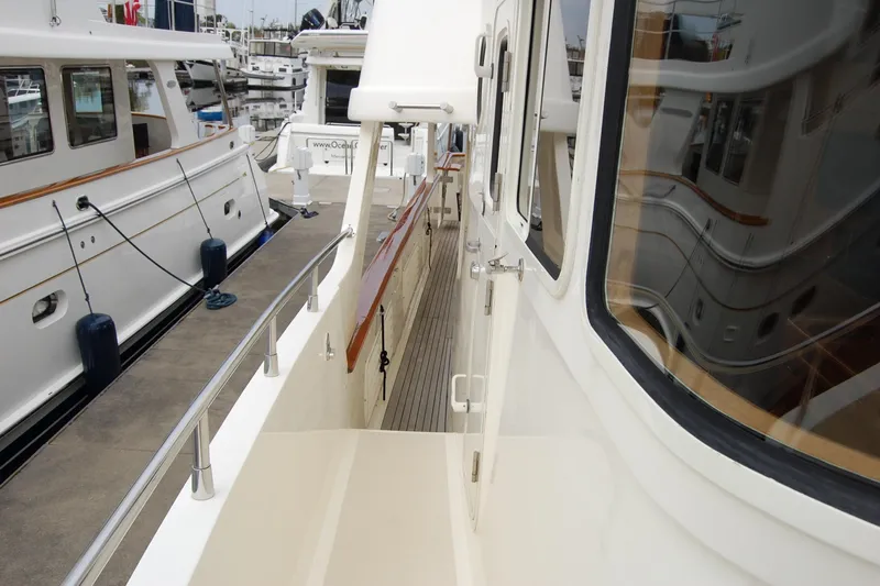 Blue Red Yacht Photos Pics 2006 Selene Pilothouse Ocean Trawler docked, showcasing side deck and marina view.