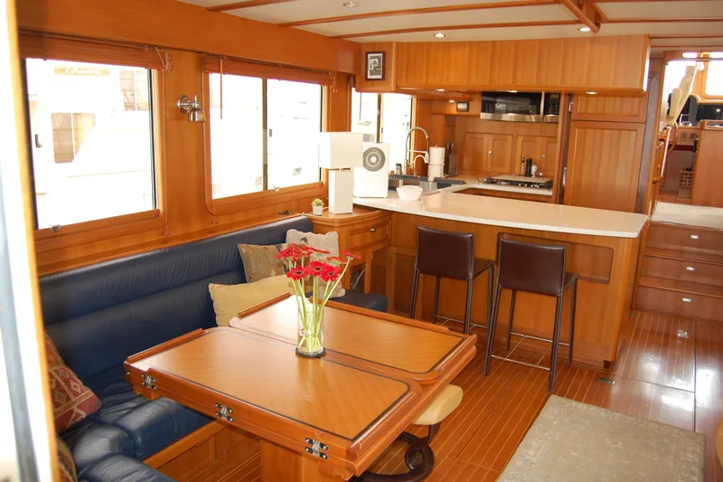 Blue Red Yacht Photos Pics 2006 Selene Pilothouse Ocean Trawler interior with wood finish, dining area, and modern kitchen.