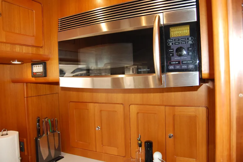 Blue Red Yacht Photos Pics Microwave in 2006 Selene Pilothouse Ocean Trawler kitchen with wooden cabinetry.