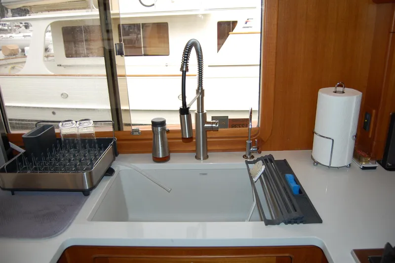 Blue Red Yacht Photos Pics Modern kitchen sink area on 2006 Selene Pilothouse Ocean Trawler with window view.