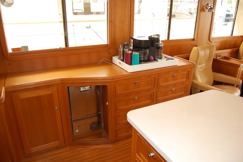 Blue Red Yacht Photos Pics Interior of 2006 Selene Pilothouse Ocean Trawler with wooden cabinetry and coffee maker.