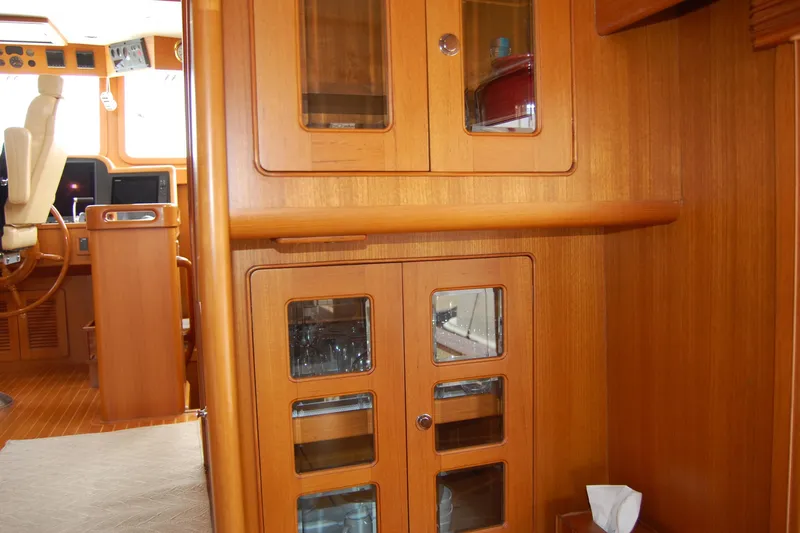 Blue Red Yacht Photos Pics 2006 Selene Pilothouse Ocean Trawler interior with wooden cabinetry and helm station.