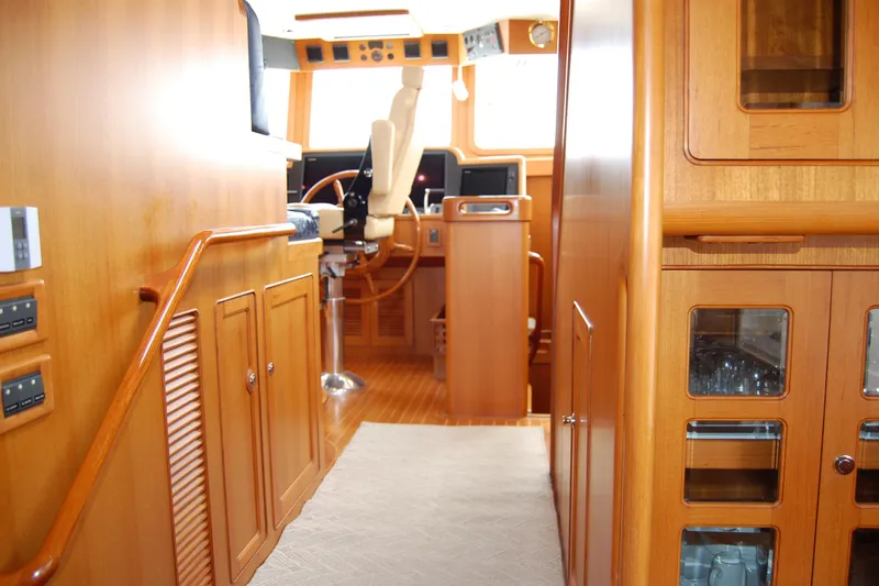 Blue Red Yacht Photos Pics Interior of 2006 Selene Pilothouse Ocean Trawler with wooden cabinetry and helm station.