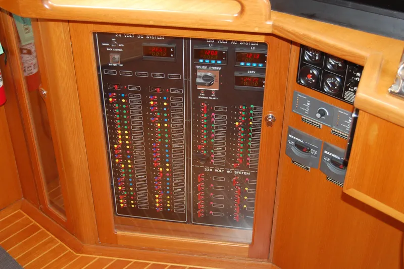 Blue Red Yacht Photos Pics Electrical control panel on 2006 Selene Pilothouse Ocean Trawler, featuring various switches and indicators.